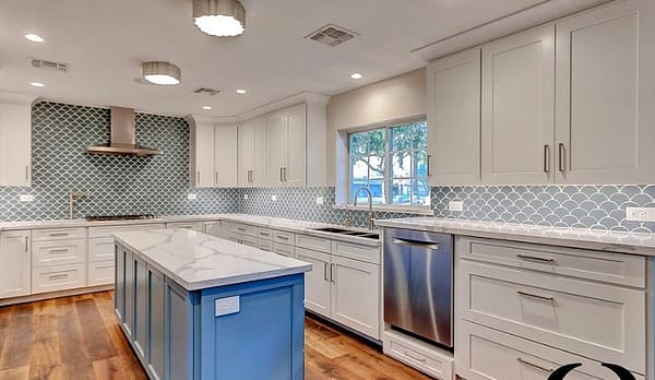 side shot of white kitchen with blue island