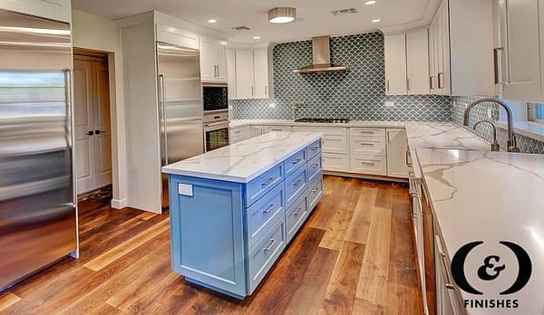 all white kitchen with blue island
