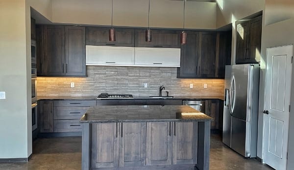 brown wood stained island and cupboards