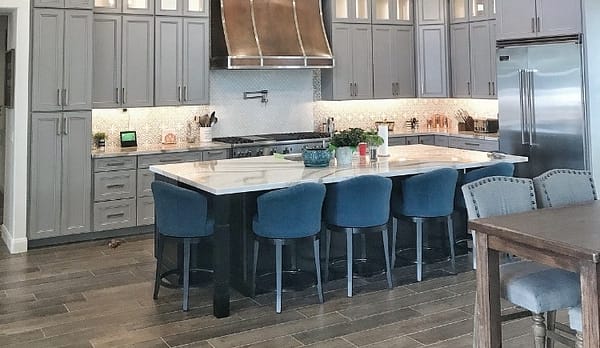 marble island with gray panel cupboards